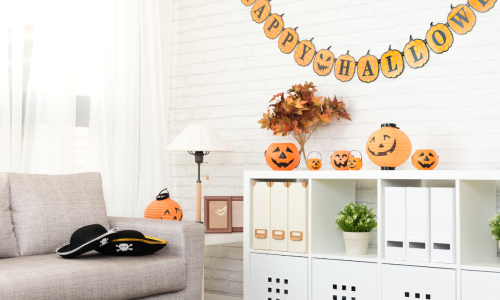  A cozy living room is decorated for Halloween, featuring a 